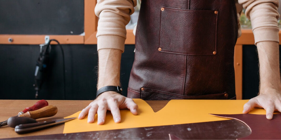 Mishnóc Galway: Leather Journals, Bags and Personal Gifts Mishnóc Galway leather craftwork with tools and leather at a workbench