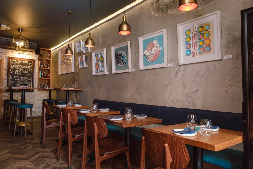 Daróg Wine Bar Galway: Small Plates and a Wine List Worth Exploring Tables and banquette seating beneath colourful artwork inside Daróg Wine Bar