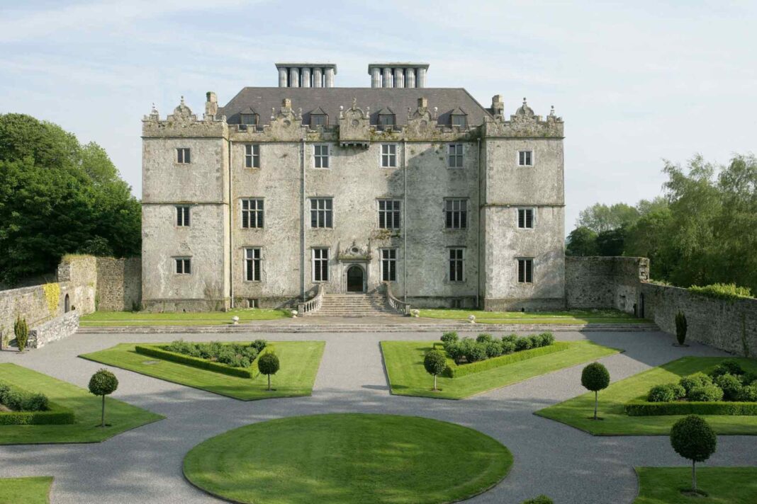 Front of Portumna Castle with geometric hedges and formal garden paths