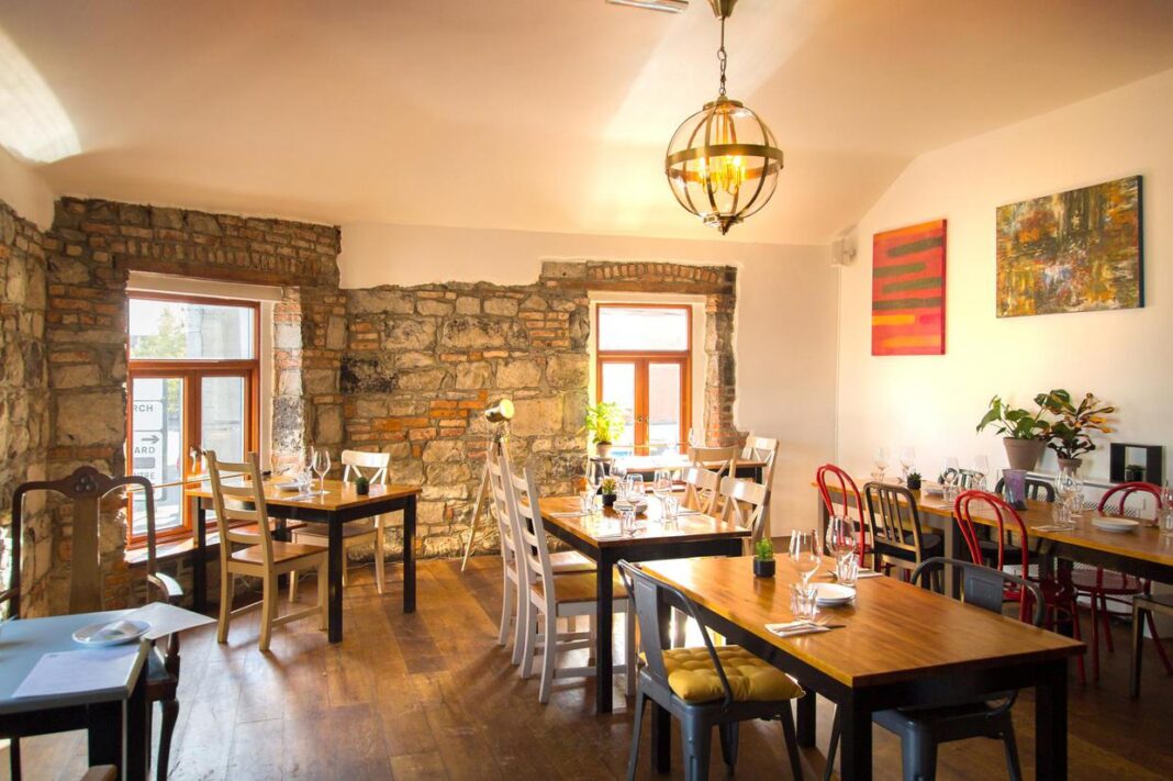 Rúibín Galway: Seasonal Food Beside the Historic Docks Rúibín dining room with exposed stone walls and tables beside bright windows